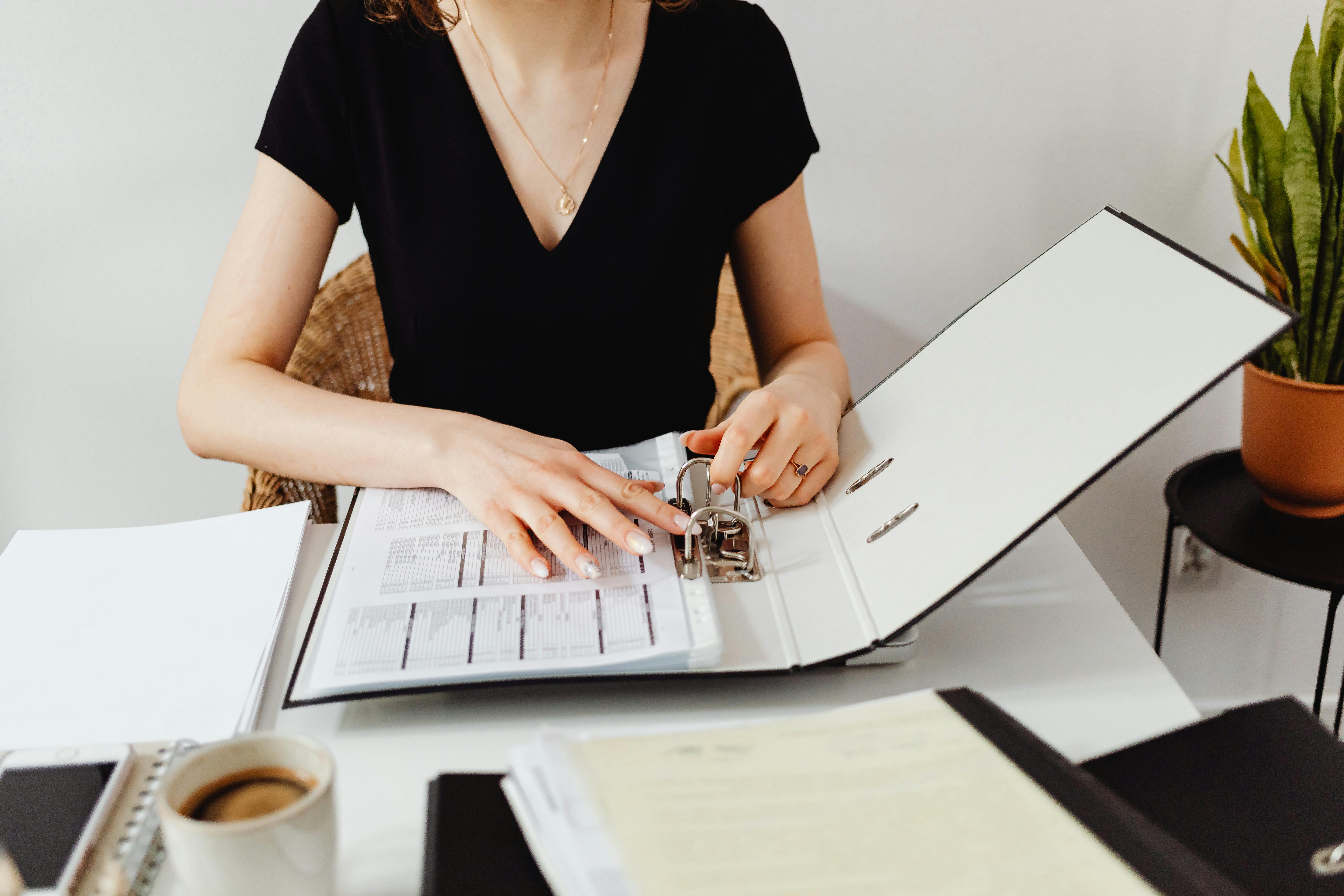 Woman reviewing a binder with data.