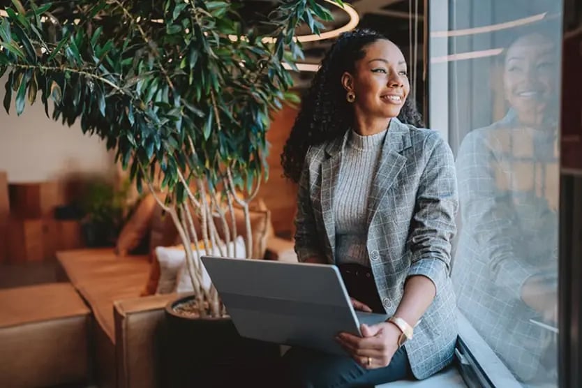 Woman in business attire with laptop