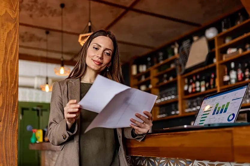 Professional reviewing documents and graphs
