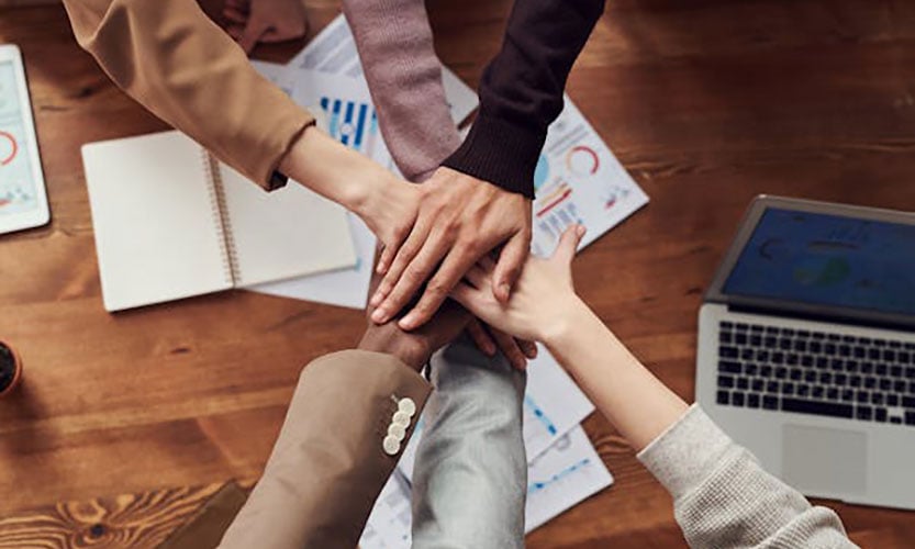 Hands together in a huddle