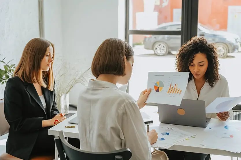 People reviewing charts at a meeting table