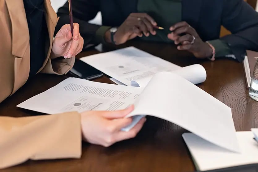 People reviewing a printed plan document