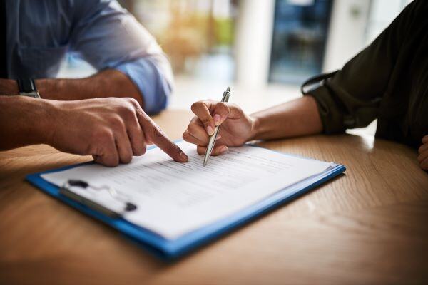 2 people signing document